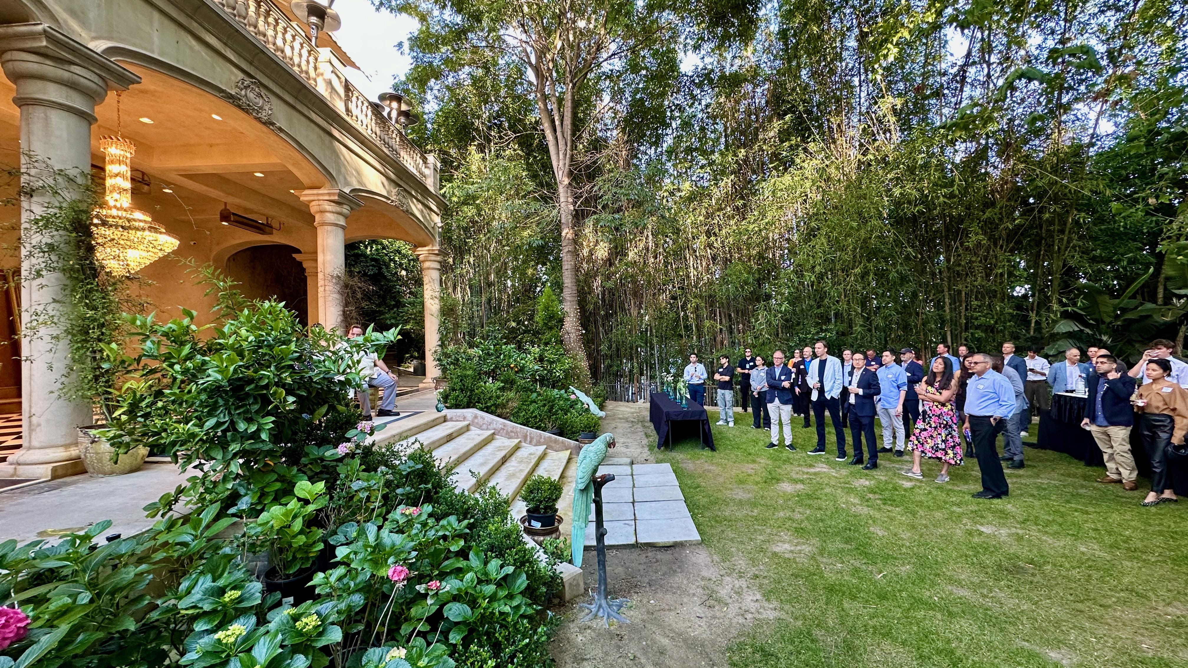 Forum guests gathered in the garden at the opening reception in Bel Air