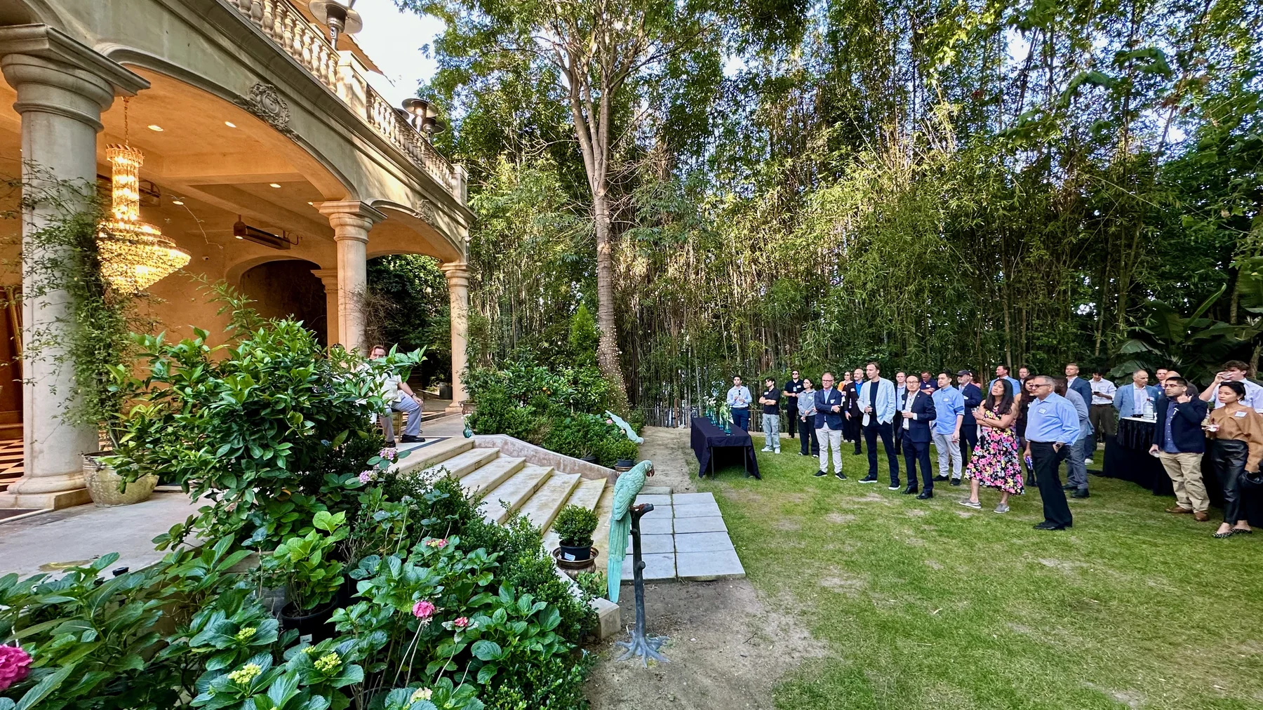 Forum guests gathered in the garden at the opening reception in Bel Air