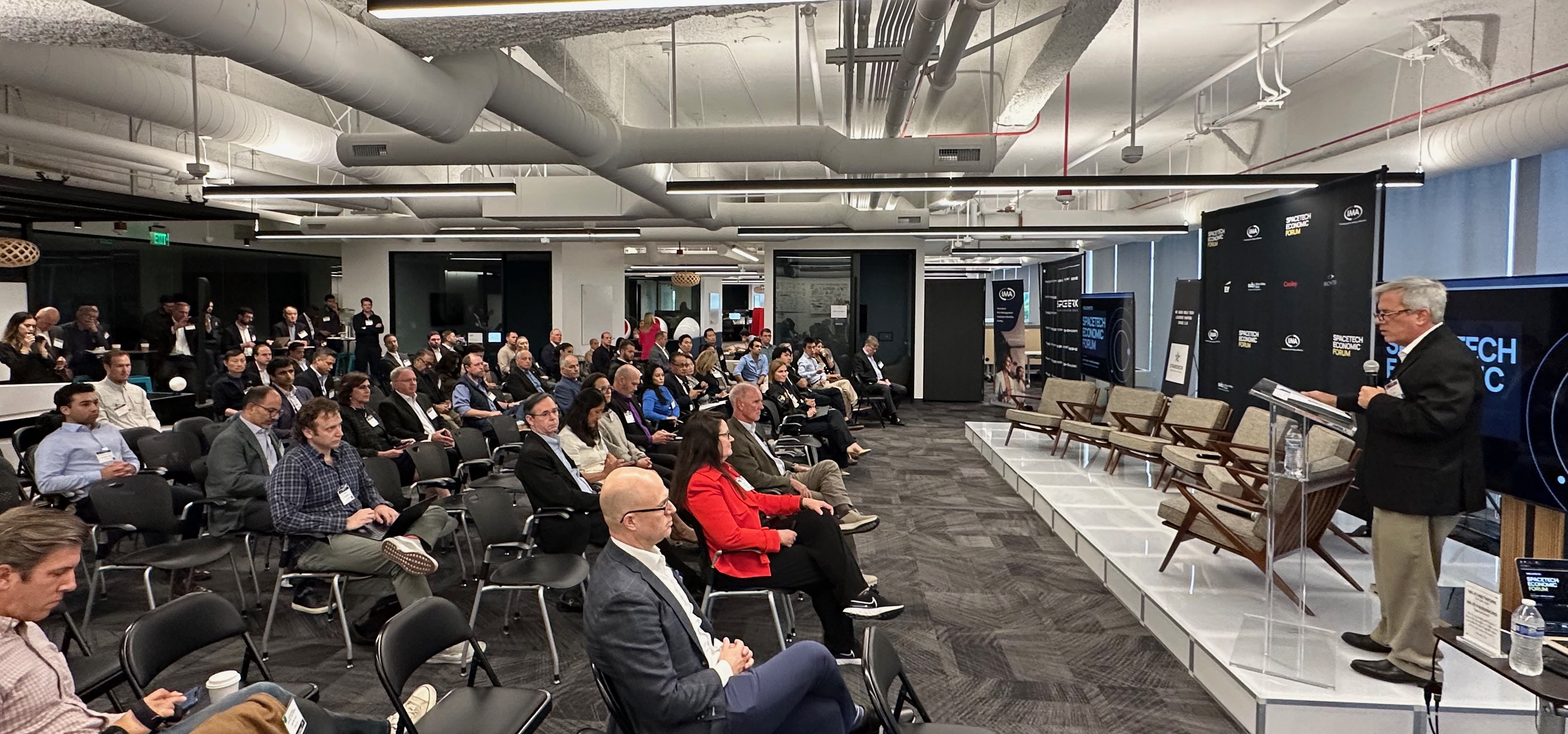 Guests listening to a speaker at the May 12 SpaceTech Economic Forum at THE BR-DGE